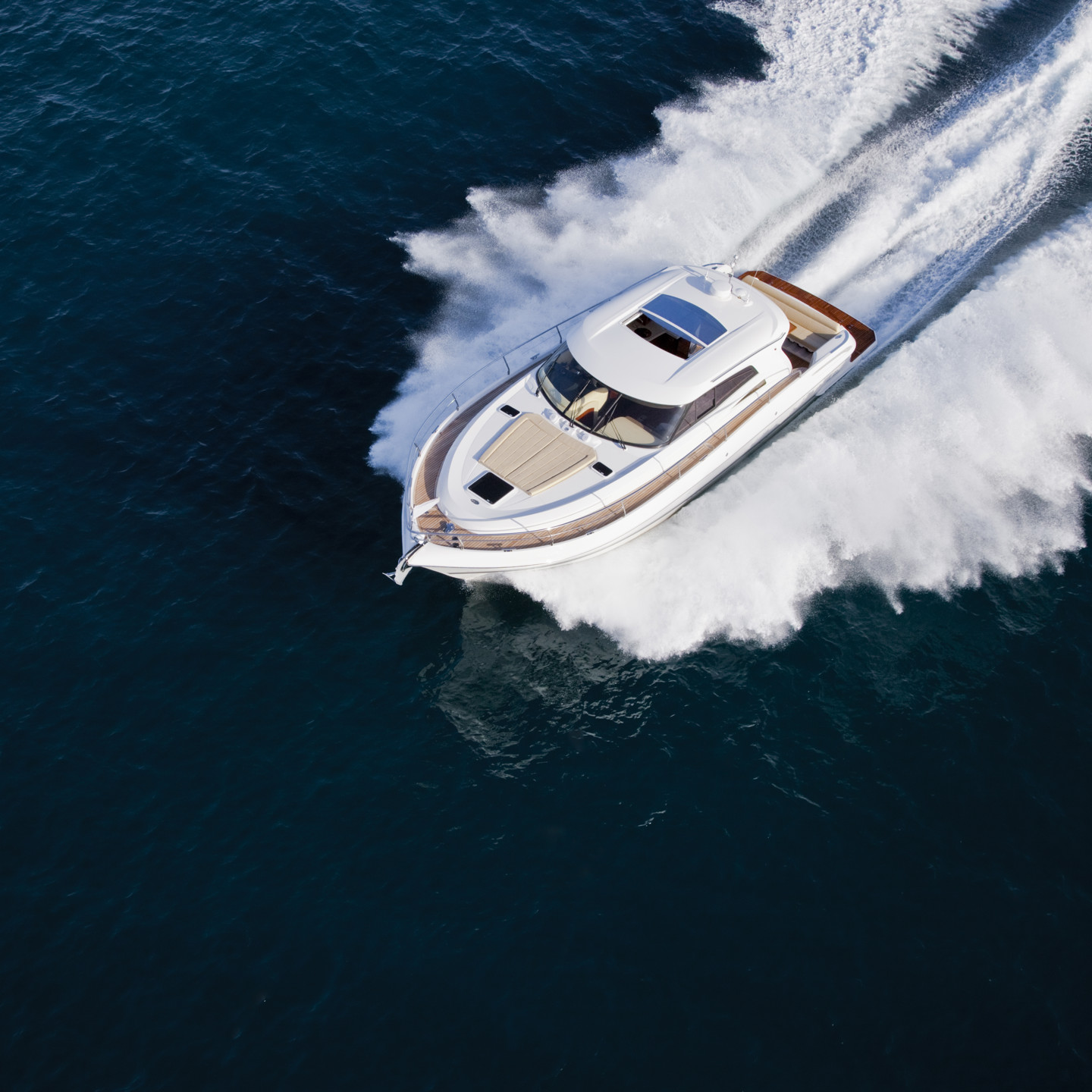 A luxurious yacht cruising through the sea on a sunny day