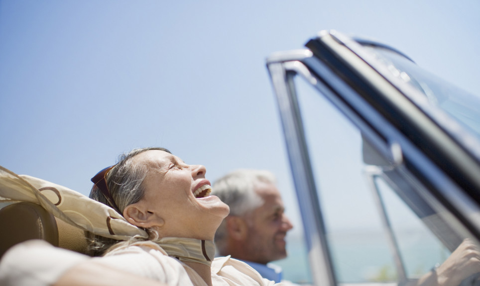Mature couple driving in convertible in the sunshine