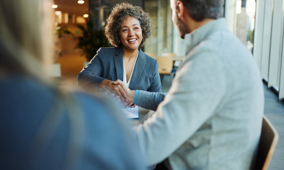 Happy multiracial businesswoman came to an agreement with her colleague during a meeting in the office.