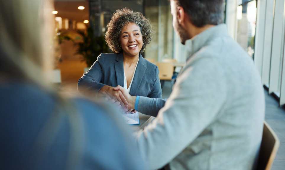 Happy multiracial businesswoman came to an agreement with her colleague during a meeting in the office.